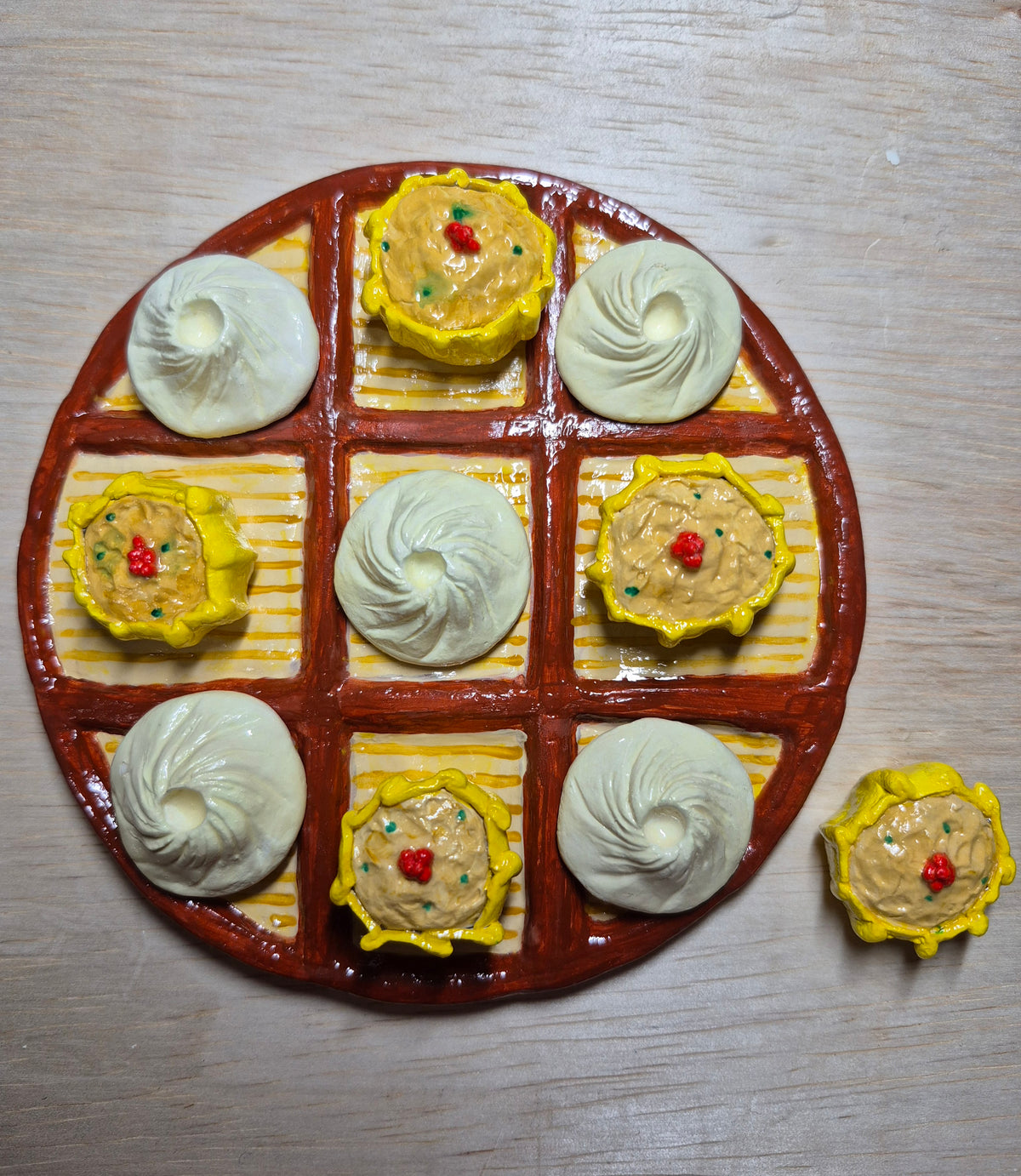 Magnetic dim sum tic-tac toe board